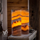 Vilona Onyx cylinder table lamp pair illuminated to reveal golden, rust red, cream, and charcoal movement