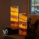 Illuminated Miami Sunset Onyx table lamp pair glowing with golden orange, amber, red, and dark brown banding