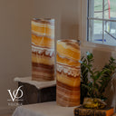 Unlit Miami Sunset Onyx table lamp pair showing natural orange, cream, burgundy, brown, and charcoal banding