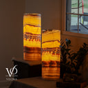 Illuminated Miami Sunset Onyx lamp pair showing translucent amber sections and dark contrasting bands