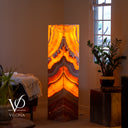Handcrafted 51.25-inch Miami Sunset Onyx floor lamp glowing warmly in a luxury living room interior