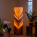 Sculptural Miami Sunset Onyx floor lamp glowing with symmetrical amber, cream, burgundy, and charcoal formations