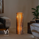 Small Aqua Onyx floor lamp glowing with a bright golden center and dramatic dark natural stone edges