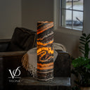 Tangerine Onyx table lamp with a curled amber formation beneath diagonal orange and charcoal bands.
