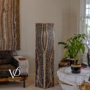 Unlit square Tangerine Onyx tower with gently curving charcoal bands, cream stone, and muted peach accents.