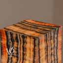 Top detail of the Tangerine Onyx floor lamp with glowing amber and charcoal bands across its polished square surface.