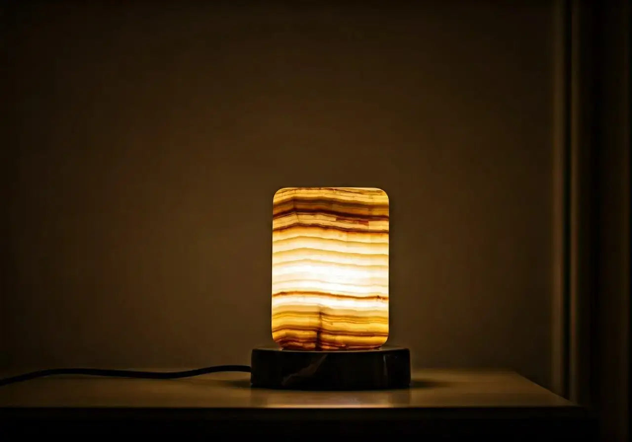 A glowing onyx lamp casts a warm light in a room. 35mm stock photo