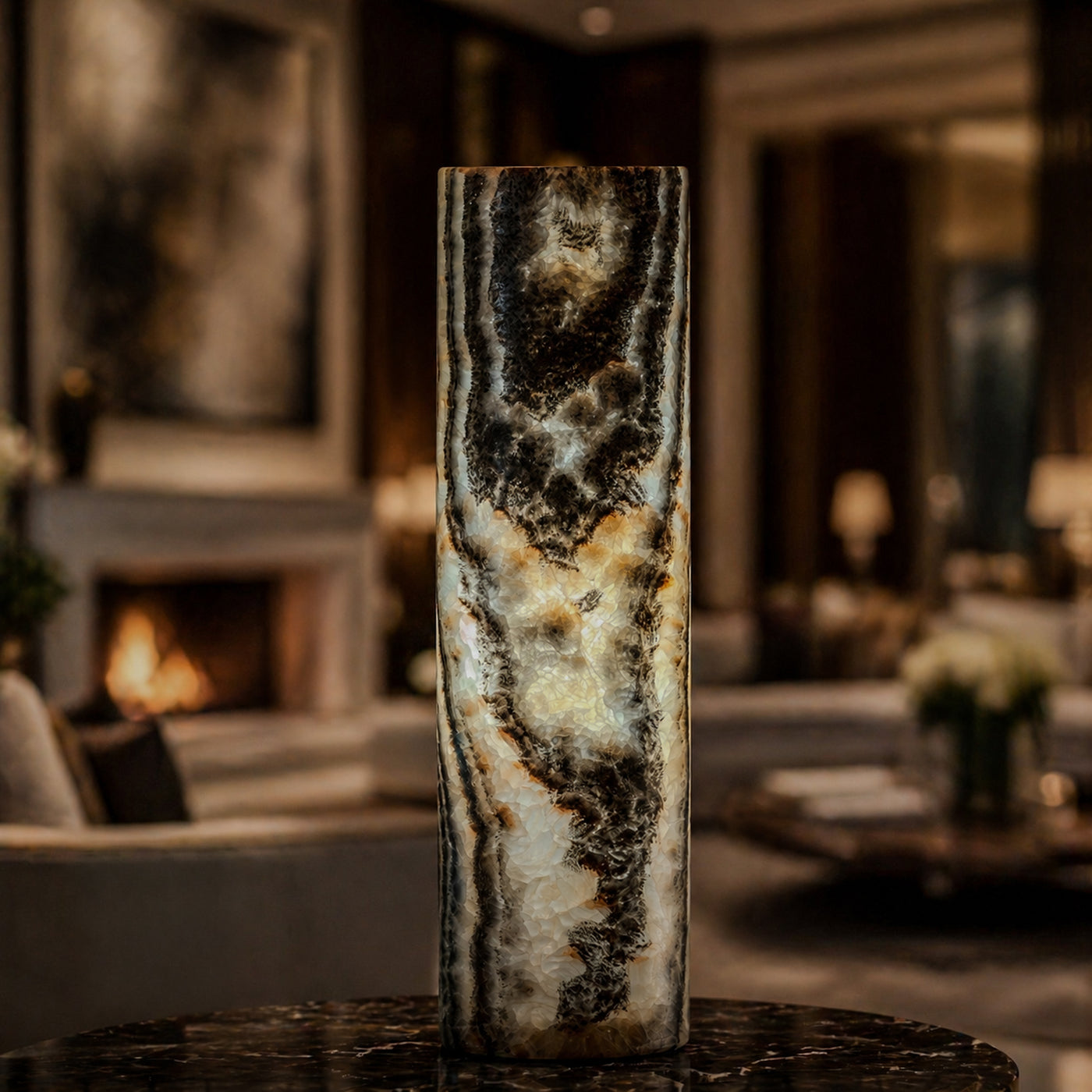 Illuminated dark natural stone tower lamp displayed beside a fireplace