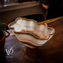 Decorative bowl on a wooden surface with 'Vilona' branding.