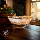 Decorative glass bowl on a wooden surface with blurred background