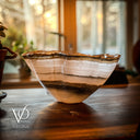 Wooden bowl with agate-like pattern on a wooden surface, blurred background