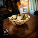 Decorative bowl on a wooden table with a blurred indoor background