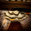 Decorative shell-shaped bowl on a wooden surface with 'Vilona' branding.