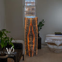 Tangerine Onyx tower lamp glowing from within with a centered flame-shaped mineral formation