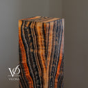 Handcrafted Tangerine Onyx floor lamp illuminated with amber, cream, charcoal, and deep brown stone layers