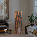 Natural Tangerine Onyx floor lamp illuminated to reveal dark mineral lines surrounding a glowing central formation