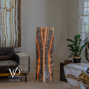 Natural Tangerine Onyx floor lamp illuminated to reveal dark mineral lines surrounding a glowing central formation