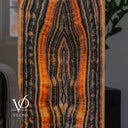 Square Tangerine Onyx tower illuminated to show translucent amber stone and bold black natural veining