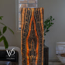Tangerine Onyx statement floor lamp glowing from within with a tall centered eye-shaped stone formation